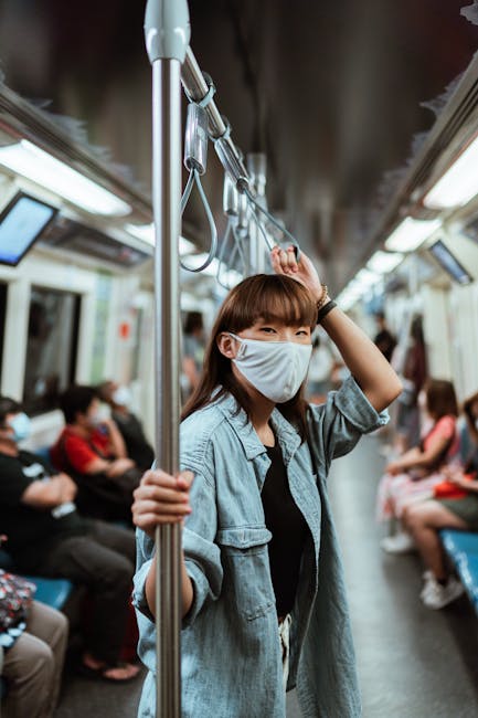 Woman in mask on a train representing public health awareness